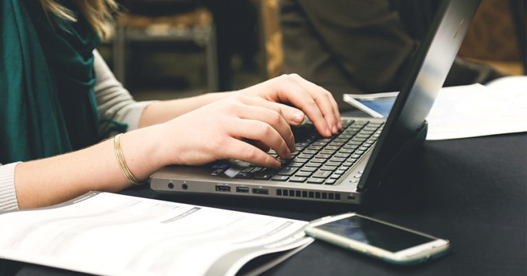 Typing on laptop