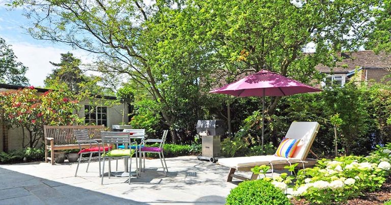 Backyard with lawn chairs and umbrella