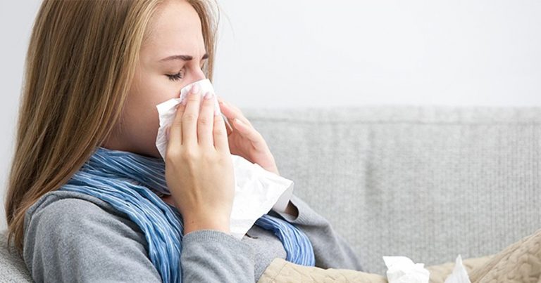 Woman blowing her nose