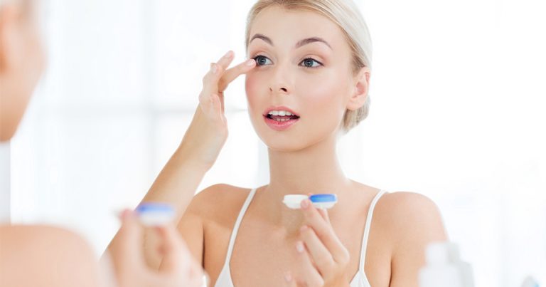 Woman putting in contacts
