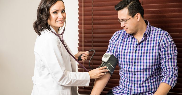 Doctor taking a man's blood pressure