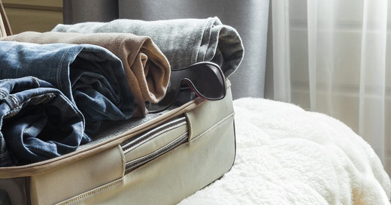 Suitcase with rolled clothes