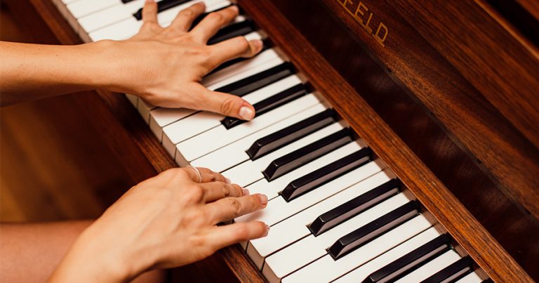 Two hands on a piano