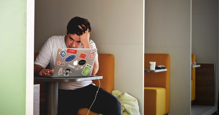 Frustrated looking guy on his laptop