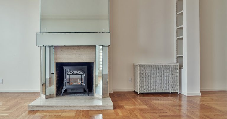 Empty room in a house with fireplace