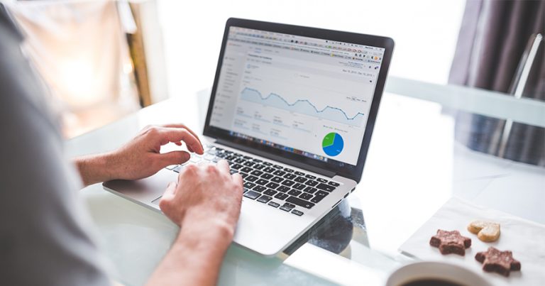 Man doing finances on laptop