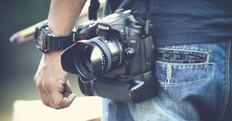 Nikon camera hanging at someone's waist