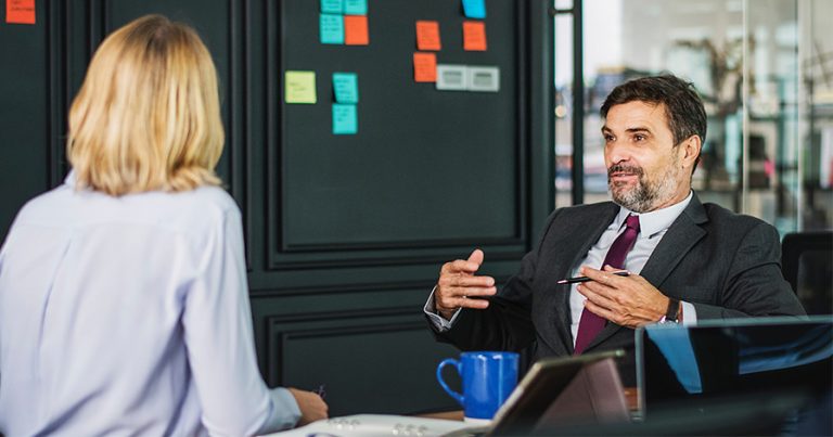 Woman talking to a man in a bank