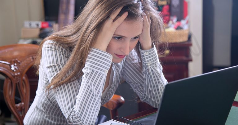 Woman staring frustrated at laptop