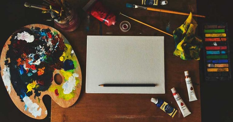 Various art supplies laid out on a table, ready for use