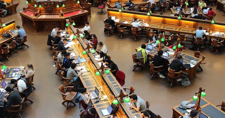 Students studying in a college library