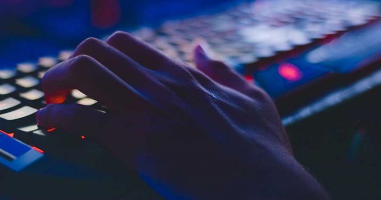 Someone typing on a gaming keyboard