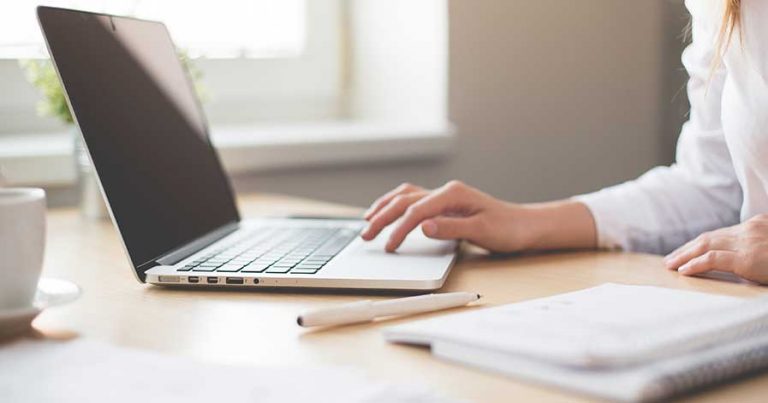 A woman doing research on a laptop