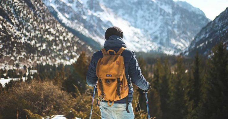 A hiker standing in front of a mountain