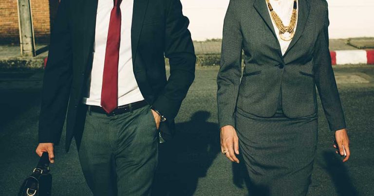 A man and woman wearing business casual outfits.