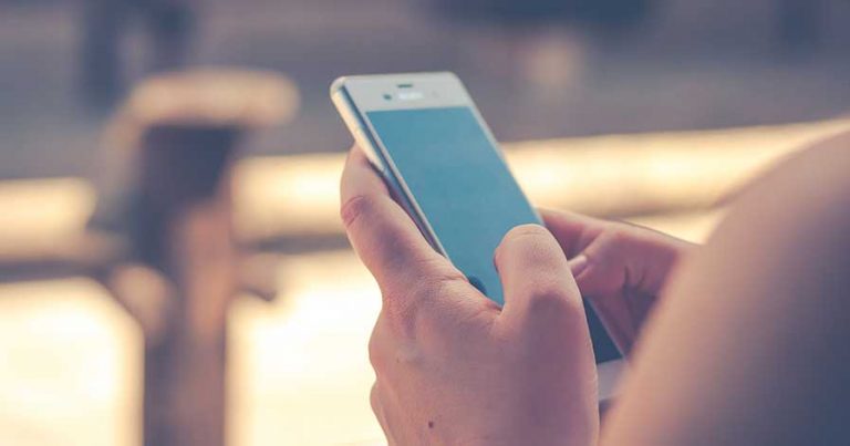 A woman holding a cell phone