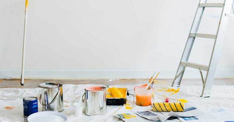 A room full of paint cans, with a ladder in the corner