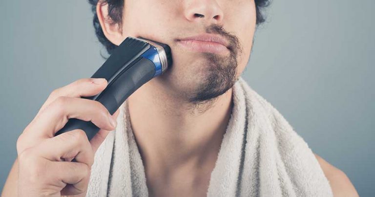 A man using an electric razor