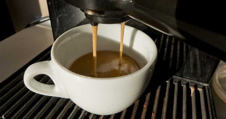 A mug being filled with coffee