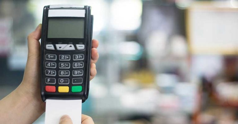Someone inserting a credit card into a POS system