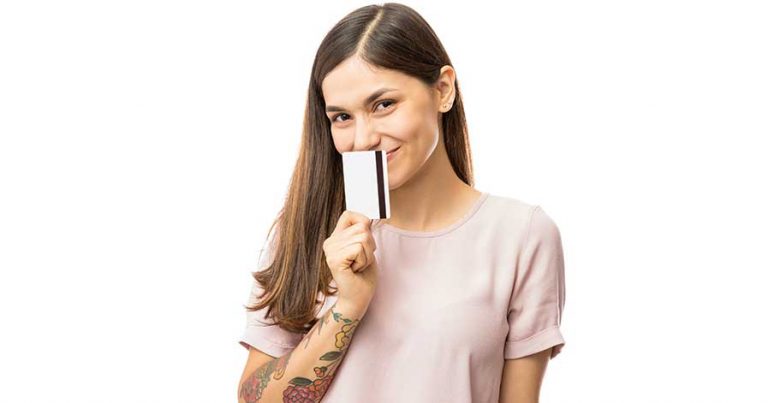 A young woman holding a credit card