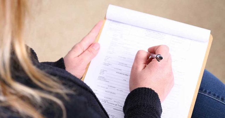 A woman filling out paper work