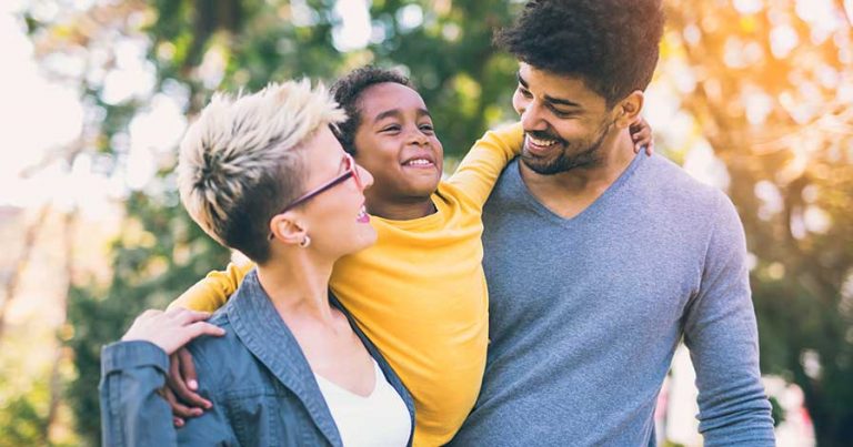 A family wearing UV protection clothing outside