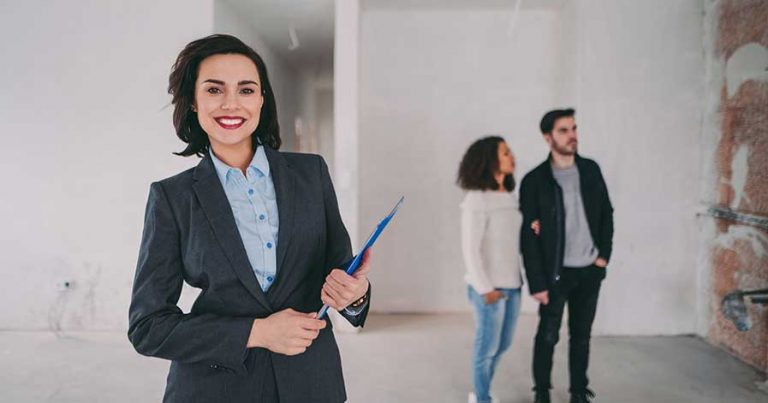 A real estate agent showing a property to a couple
