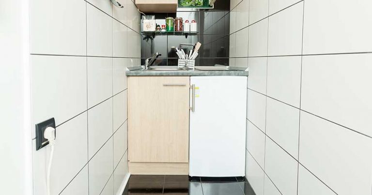 A kitchen with a mini fridge