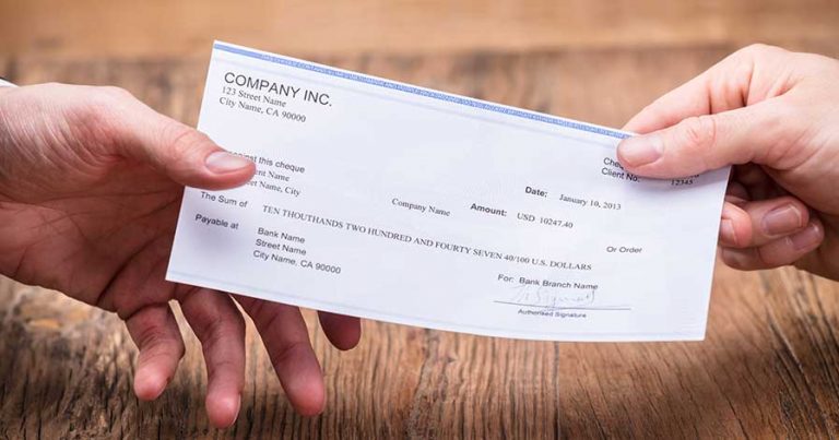Two hands holding a generic check
