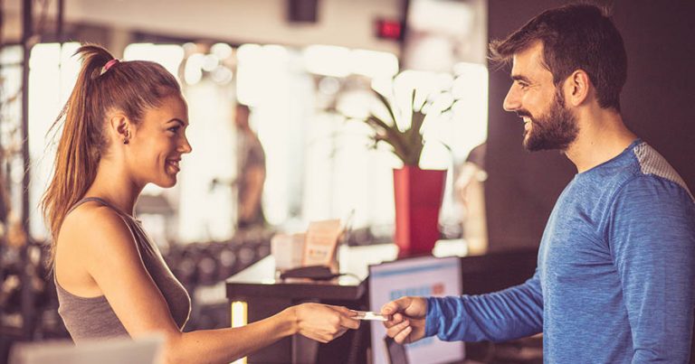 Woman taking key and checking at gym