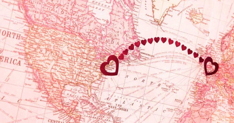 A map with hearts on it connecting New York to London, England