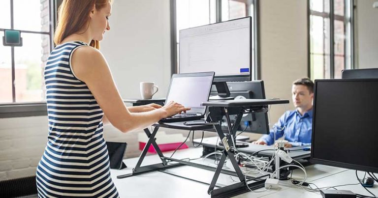 A woman using a standing desk