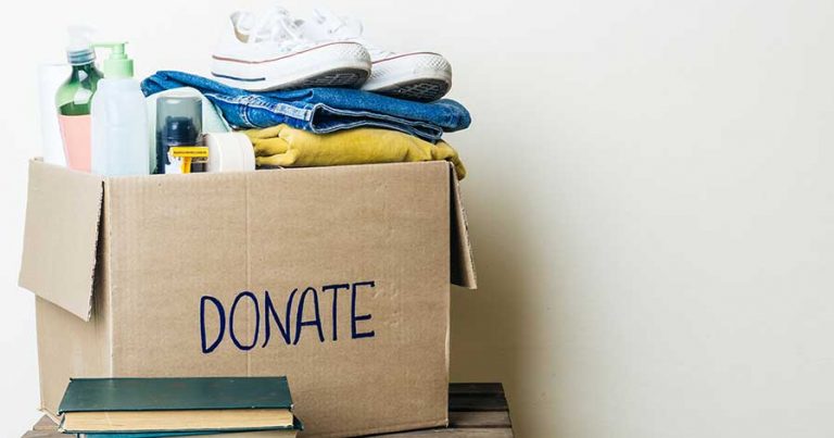 A box of clothing items marked for donation