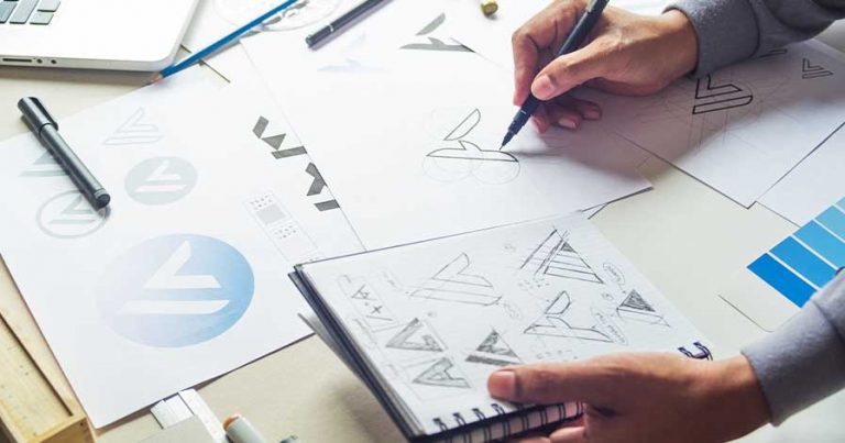 A person drawing logo designs.