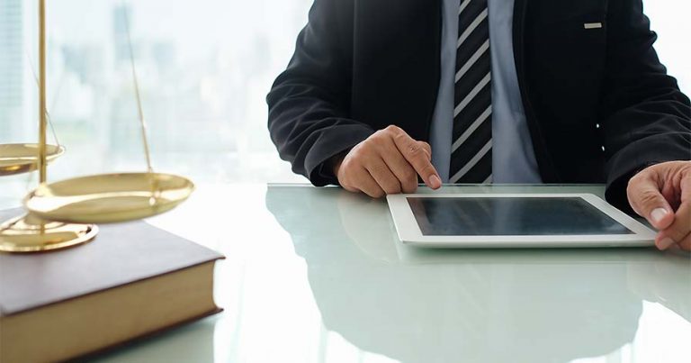 A notary reviewing a contract on a tablet.